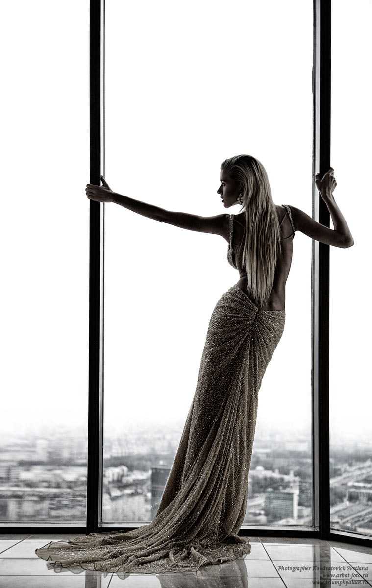 Between the lines | window, long dress, blond, skyscraper