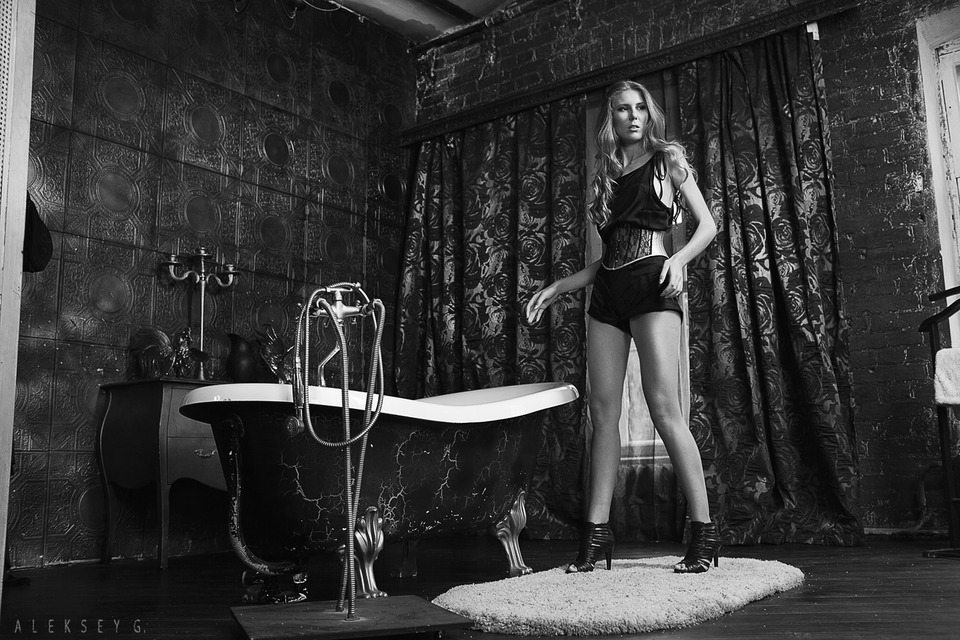 Black & white photo of a girl in a bathroom | glamour, model, girl, black & white, blonde, bath, black, rug, long legs, curtain