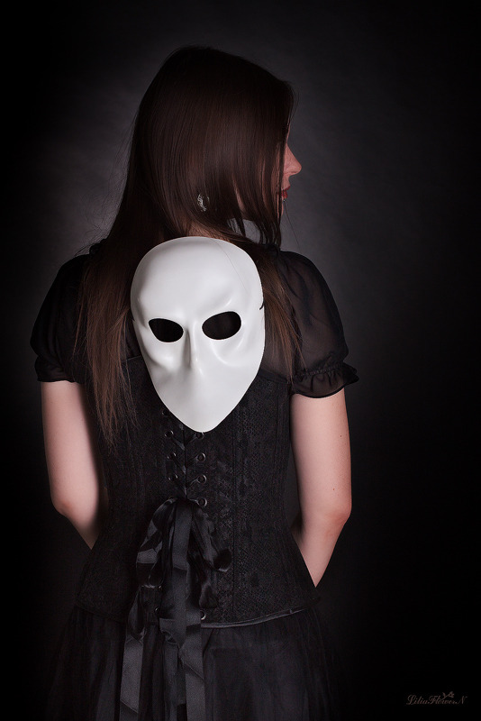 Gorl with the mask on her back | mask, girl, back, black dress